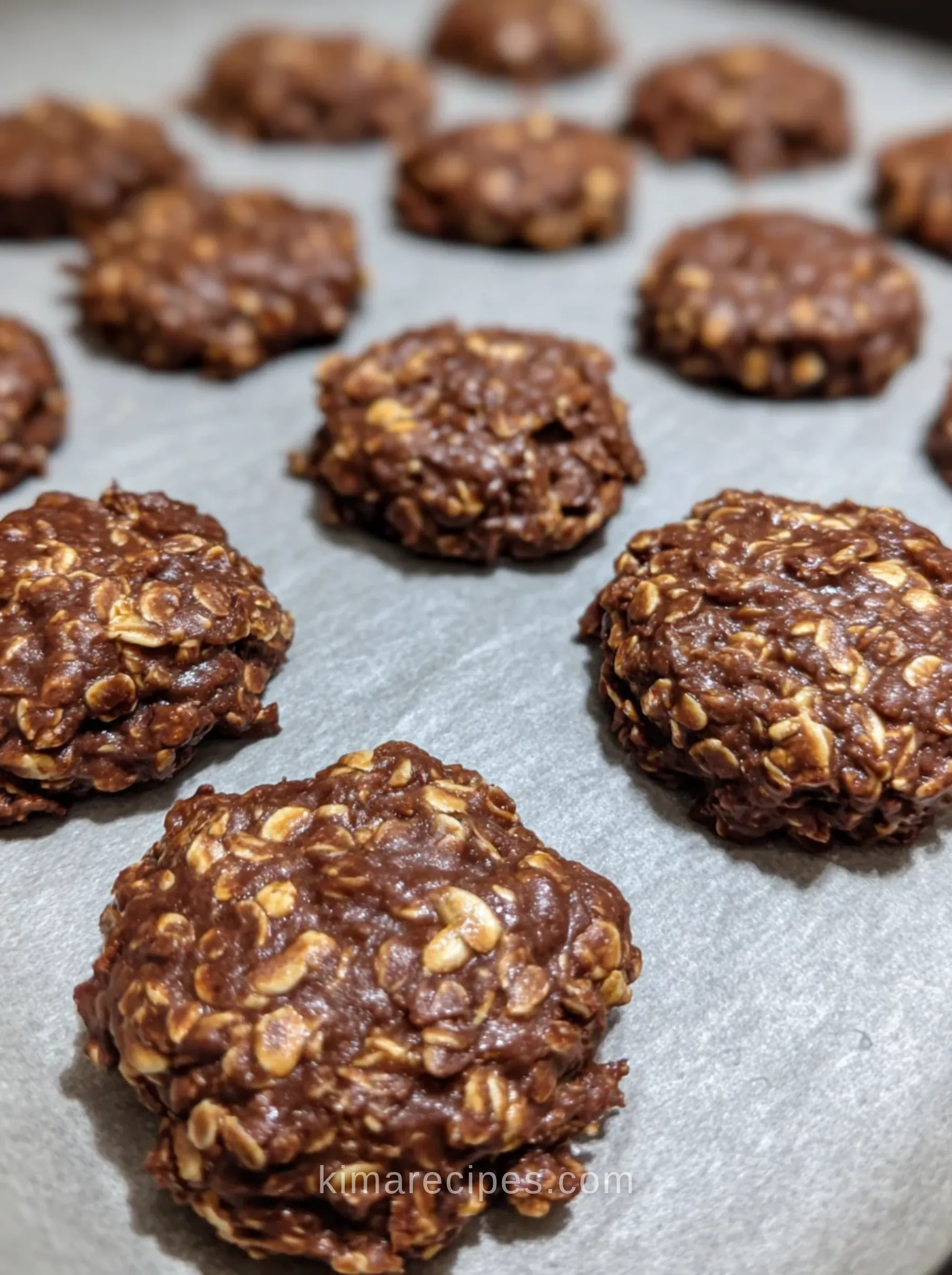 Close-up of chocolate peanut butter no bake cookies with oats on parchment paper