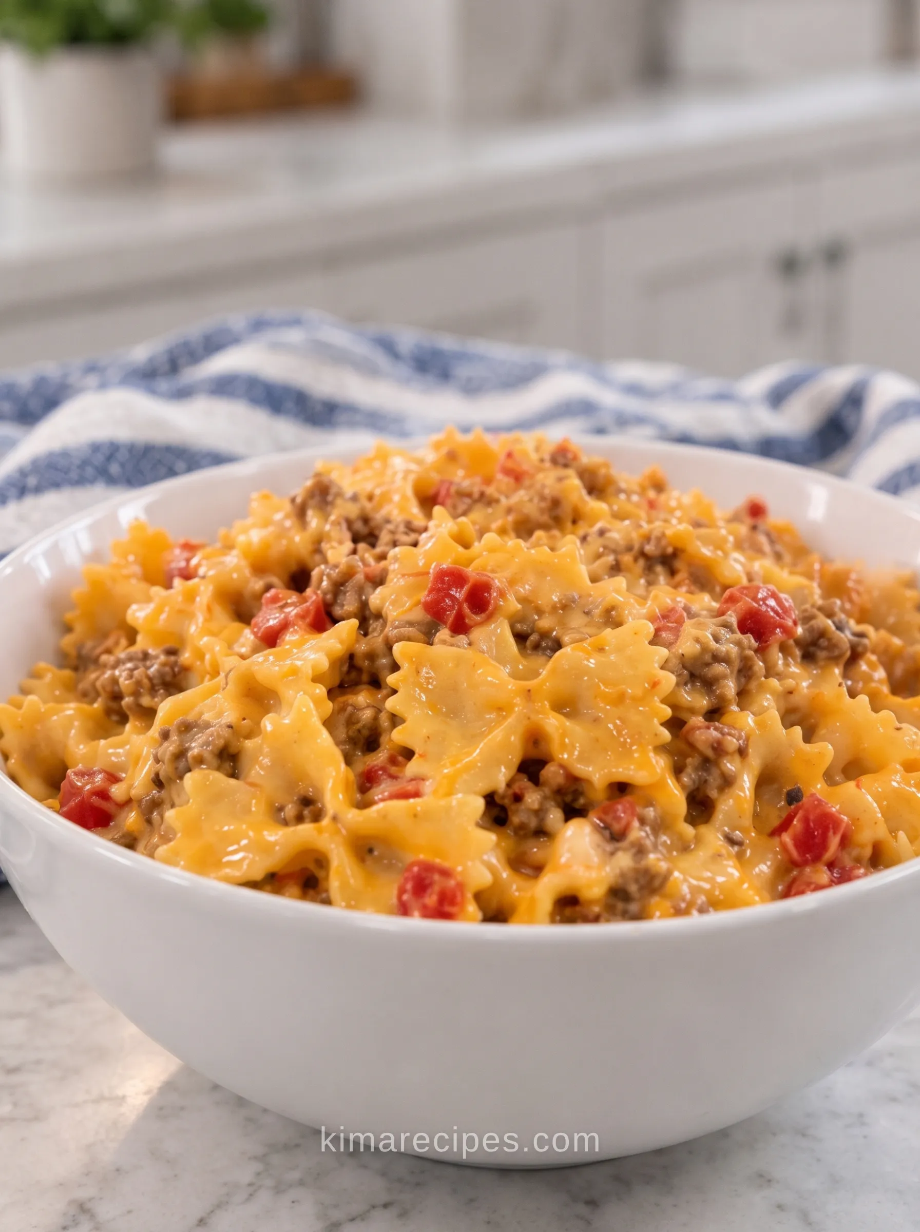 Slow cooker cheesy taco bowtie pasta with ground beef and Rotel tomatoes in a creamy cheese sauce, served in a white bowl